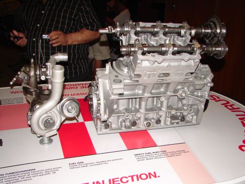 1992 Ford Taurus - A display shows an engine block and a turbocharger, with text indicating it is related to the Taurus.