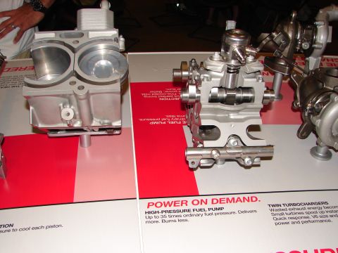 1992 Ford Taurus - Display of engine components including a fuel pump and engine block.