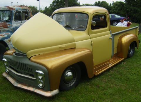 2007 Ford Mustang - Customized pickup truck with hood up, parked on grass next to a rusty truck.