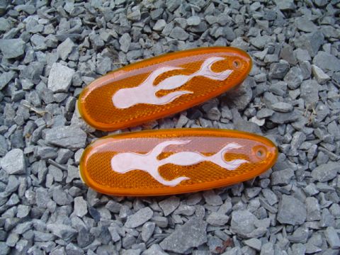 1999 Ford Taurus - These orange side marker lights feature white flame decals and are shown against a gravel background.
