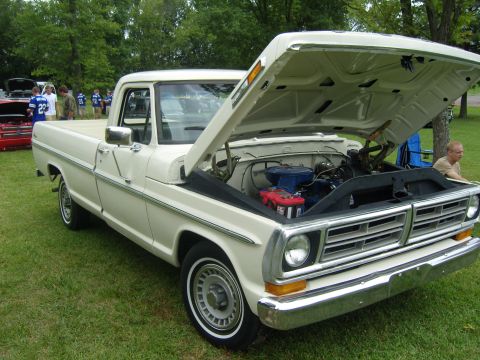 2007 Ford Mustang - A classic white pickup truck is displayed with its hood open, revealing the engine compartment.