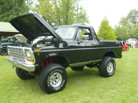 2007 Ford Mustang - A black Ford Bronco is displayed with its hood open at an outdoor event.