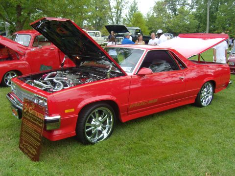 2007 Ford Mustang - A red El Camino is displayed with its hood and trunk open, its engine and custom features.