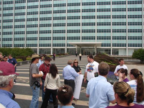 1992 Ford Taurus - People assemble in front of a large, modern office building with a distinctive patterned walkway.