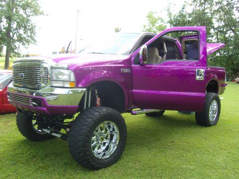 2007 Ford Mustang - This lifted Ford F-250 Super Duty truck is displayed with its doors open, its custom purple paint job.