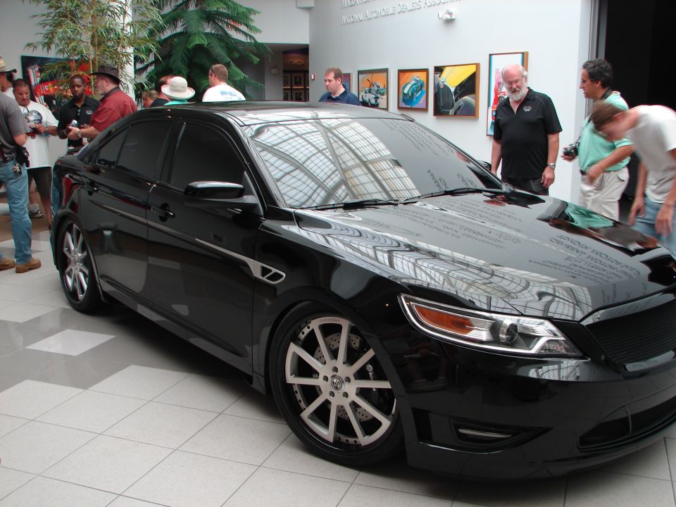 Black sedan with custom wheels and body kit