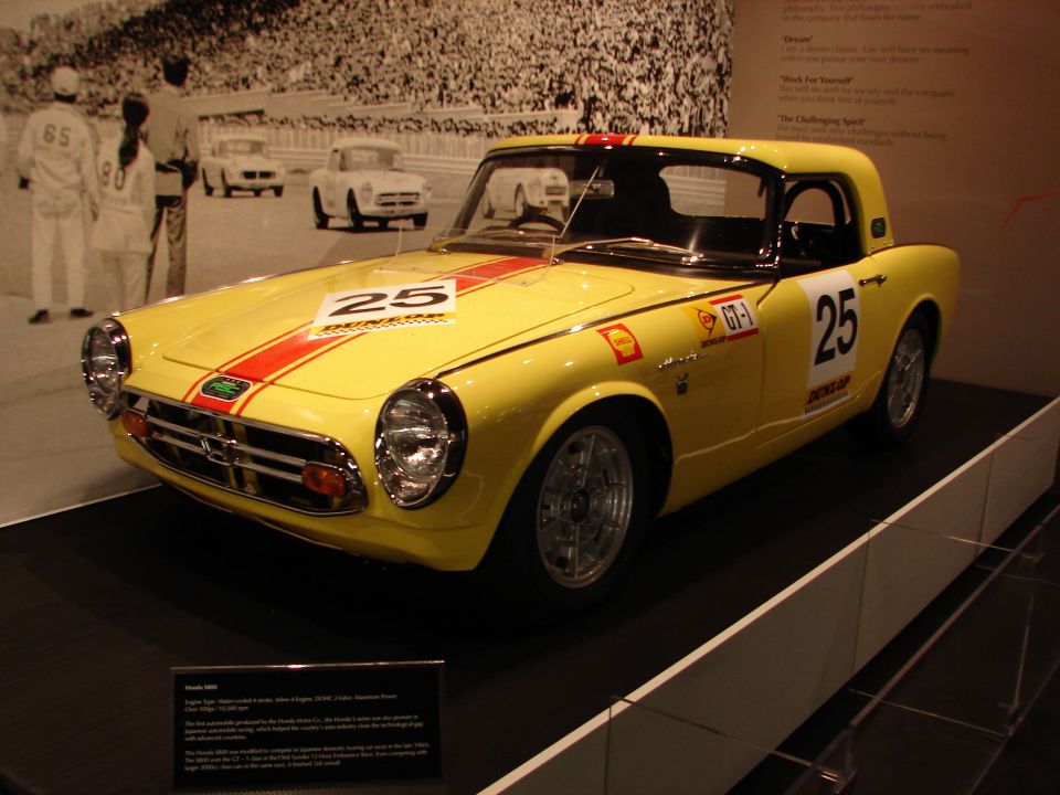 Yellow Honda S600 coupe with red stripes and number 25 on hood and door