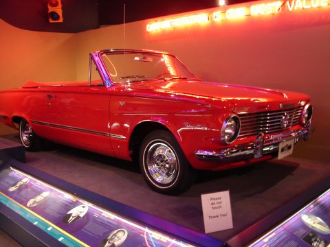 1992 Ford Taurus - A vintage red convertible is displayed indoors, with a sign indicating it should not be touched.
