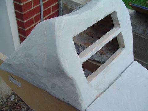 1999 Ford Taurus - This automotive part is covered in primer and features two rectangular openings with wooden bracing inside.