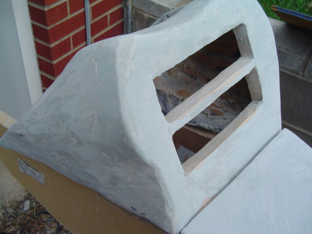 Car part in primer with rectangular openings and wooden supports