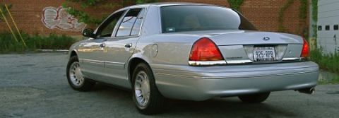 2000 Ford Crown Victoria - Rear view of a silver 2000 Ford Crown Victoria sedan parked outdoors.