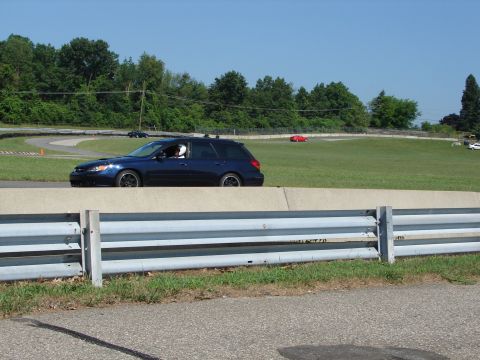 1992 Ford Taurus - Station wagon on a race track with other vehicles visible in the background.