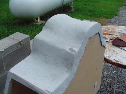 1999 Ford Taurus - A custom body panel, likely for a vehicle, is shown covered in primer and undergoing modification.