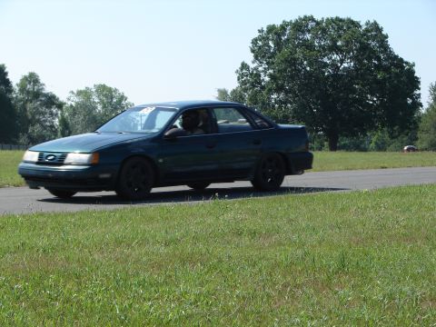 1992 Ford Taurus - A 1992 Ford Taurus is seen driving on a road during the day.
