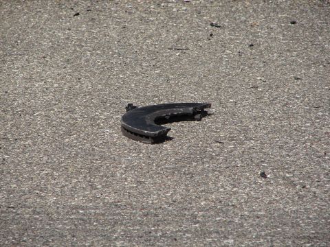 1992 Ford Taurus - A damaged brake rotor lies on the ground, indicating a potential vehicle issue.