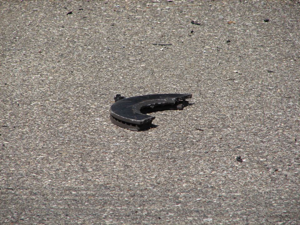 broken brake rotor on asphalt