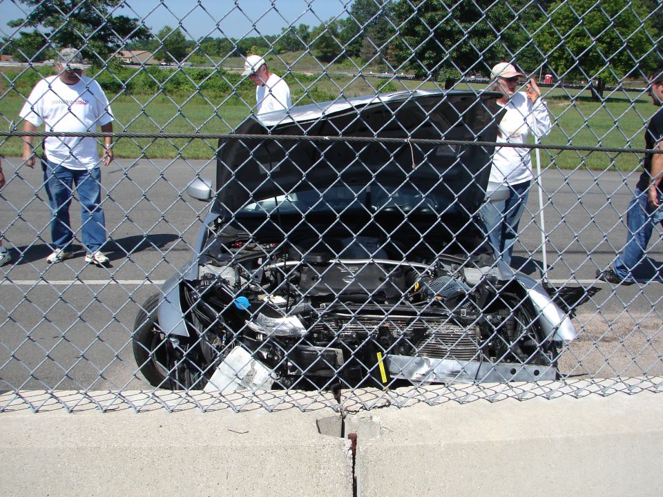 Silver car front view with hood open, engine exposed
