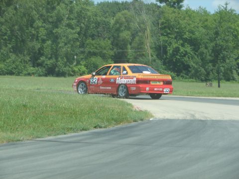 1992 Ford Taurus - This race car, identified as a Ford Taurus, is seen on a track with "Motorcraft" branding and the number 32.