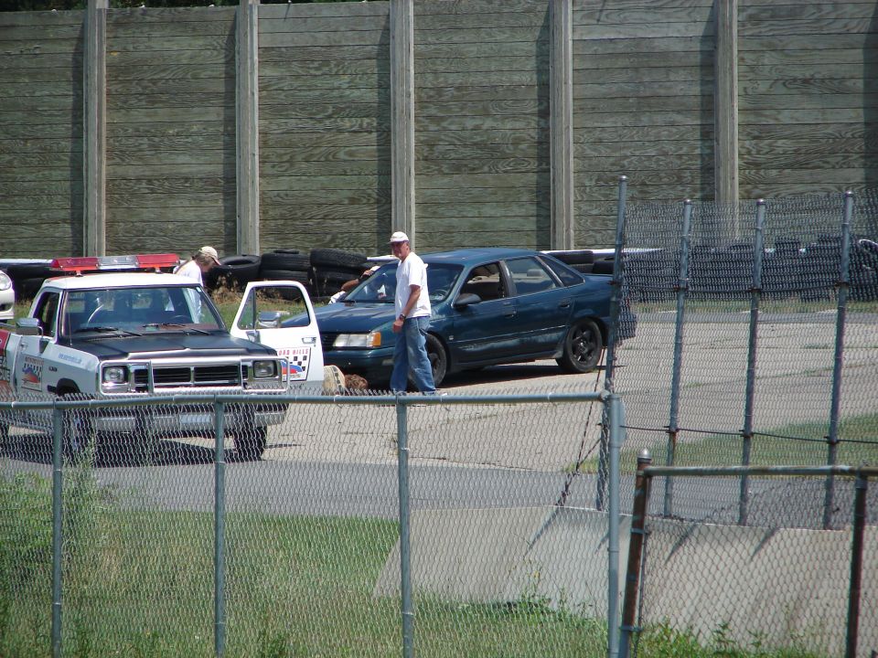 Dark blue sedan with a spoiler, seen from the side
