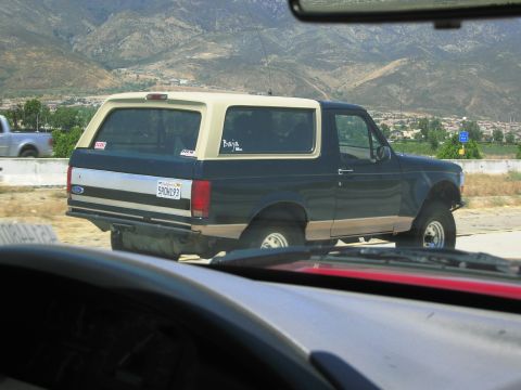 1986 Ford Bronco - Rear view of a Ford Bronco with a Baja sticker, seen on the highway.