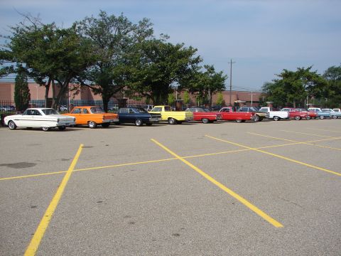 1992 Ford Taurus - A row of vintage automobiles are parked in an outdoor lot under a partly cloudy sky.
