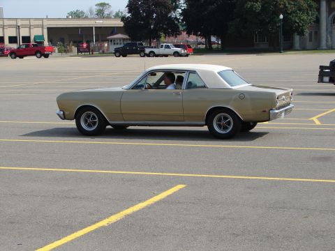 1992 Ford Taurus - This classic gold coupe with a white vinyl roof is seen from the side.