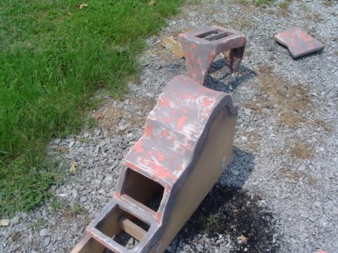 1999 Ford Taurus - Unidentified car interior console parts are shown in primer stage on a gravel surface.