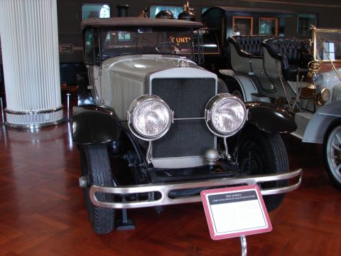 1992 Ford Taurus - A 1924 Dodge Brothers car is displayed indoors, with a descriptive sign in front of it.