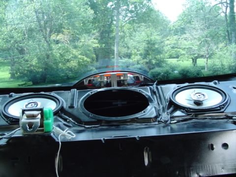 1999 Ford Taurus - The interior speaker assembly of a 1999 Ford Taurus is visible, with wiring and a green clip attached.
