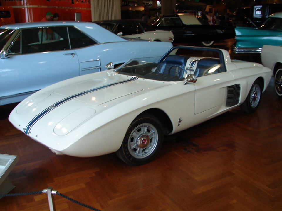 White sports car with blue stripes and a black interior