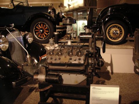 1992 Ford Taurus - A V-8 engine from a 1932 Ford is displayed alongside other classic automobiles.