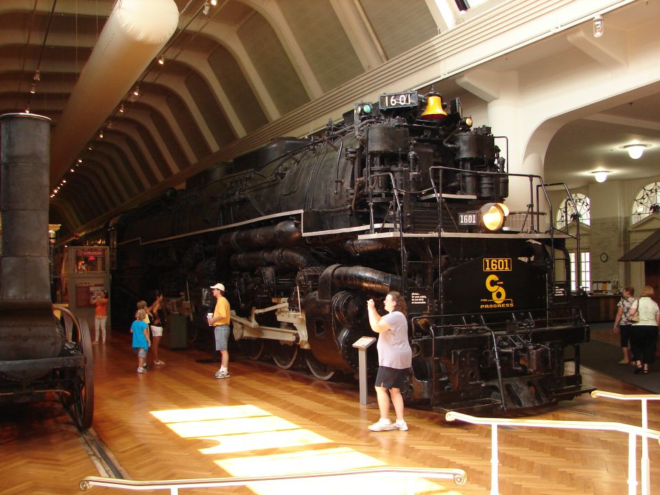 large black steam locomotive with number 1601 on front, inside a museum