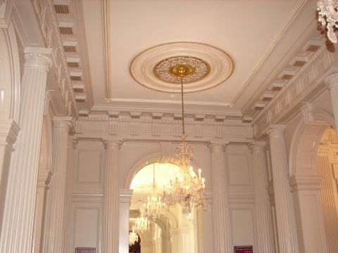 1992 Ford Taurus - An ornate interior scene with chandeliers and classical architectural elements is shown.