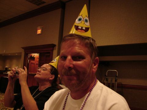 1992 Ford Taurus - Two people wearing Spongebob-themed party hats at an indoor event.