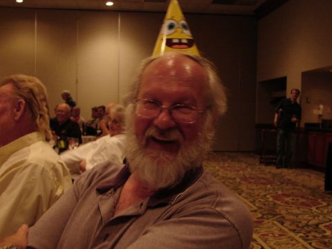 1992 Ford Taurus - A man wearing a Spongebob hat smiles at a convention event.