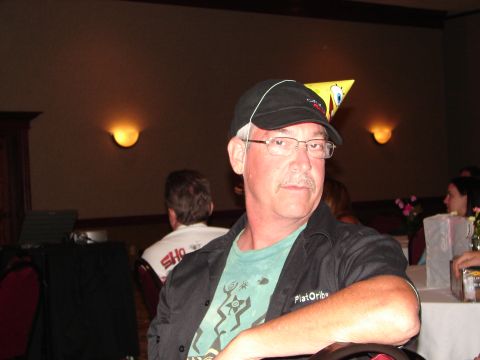 1992 Ford Taurus - Man wearing glasses and a black baseball cap with a party hat on his head.