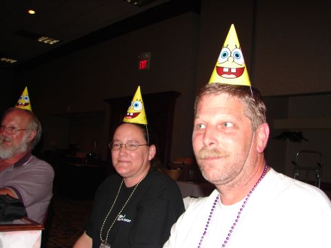 1992 Ford Taurus - People are wearing Spongebob Squarepants themed party hats at an indoor event.