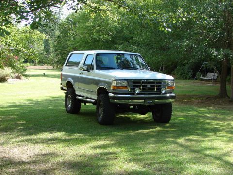 1995 Ford Bronco - This lifted 1995 Ford Bronco is parked on a sunny day in a grassy yard.