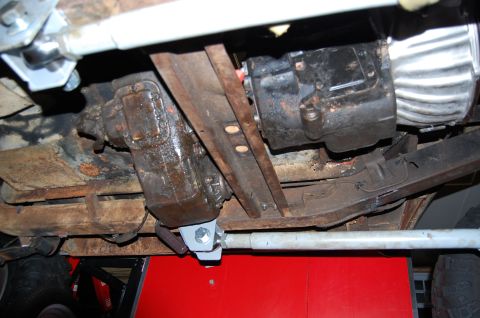 1994 Ford Bronco - The undercarriage of a vehicle is shown, focusing on the transmission and transfer case assembly.