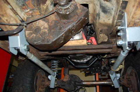 1994 Ford Bronco - Undercarriage view shows the drivetrain, transfer case, and suspension of a vehicle.