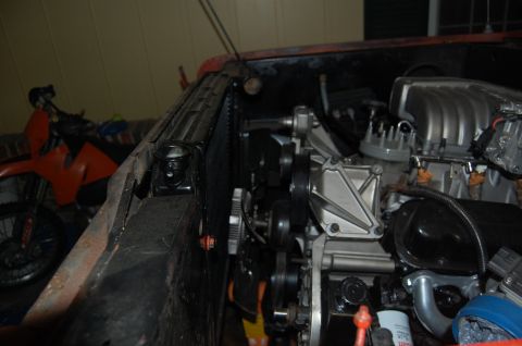 1994 Ford Bronco - Close-up view of a vehicle's engine and radiator, with a motorcycle visible behind it.