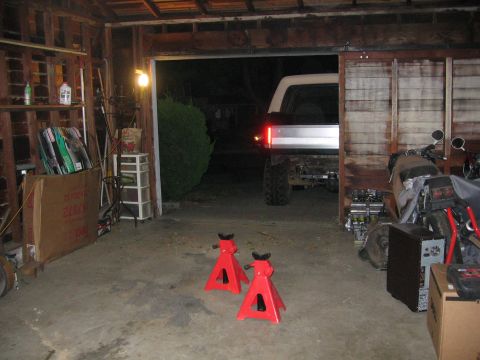1989 Ford Bronco - A white Ford Bronco is parked in a garage, viewed from the rear.