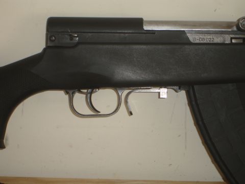 1989 Ford Bronco - Close-up view of a firearm's receiver, showing the trigger assembly and a visible serial number.