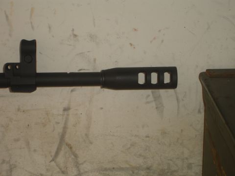 1989 Ford Bronco - Close-up of a gun barrel with a muzzle brake.