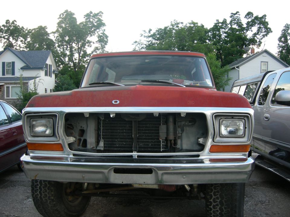 Red 1979 Ford Bronco front view with missing grille