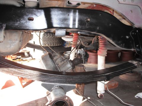 1991 Ford Bronco - Undercarriage components including leaf springs, shocks, and frame structure are visible.
