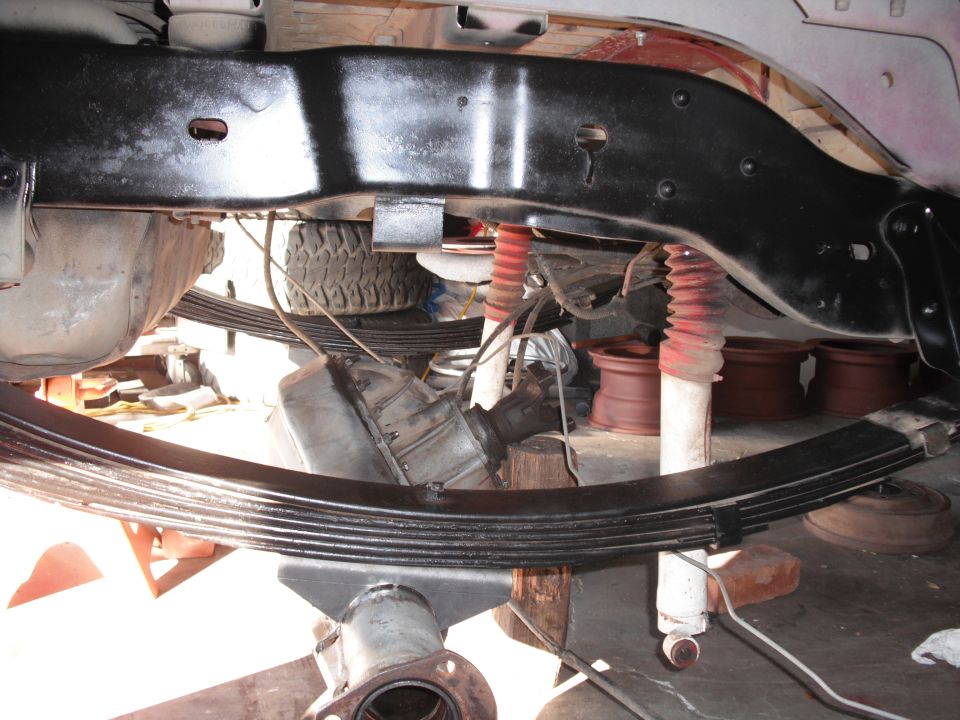 Undercarriage view showing leaf springs, shocks, and part of the frame