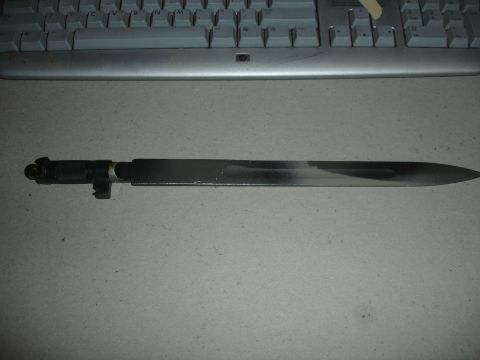 1989 Ford Bronco - A bayonet is shown, likely for sale, with a keyboard in the background.