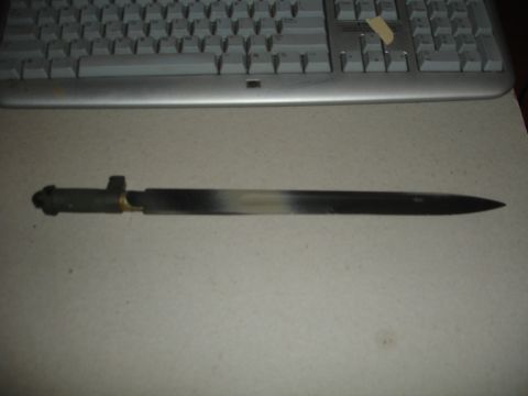 1989 Ford Bronco - A bayonet is shown in front of a computer keyboard.