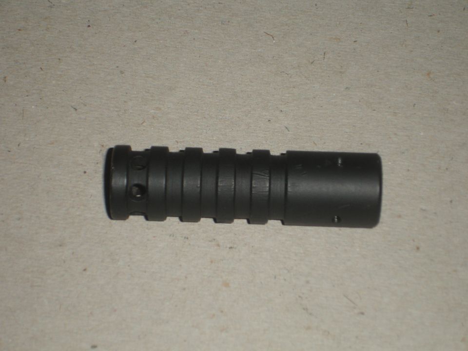 black cylindrical part with multiple ridges and some holes